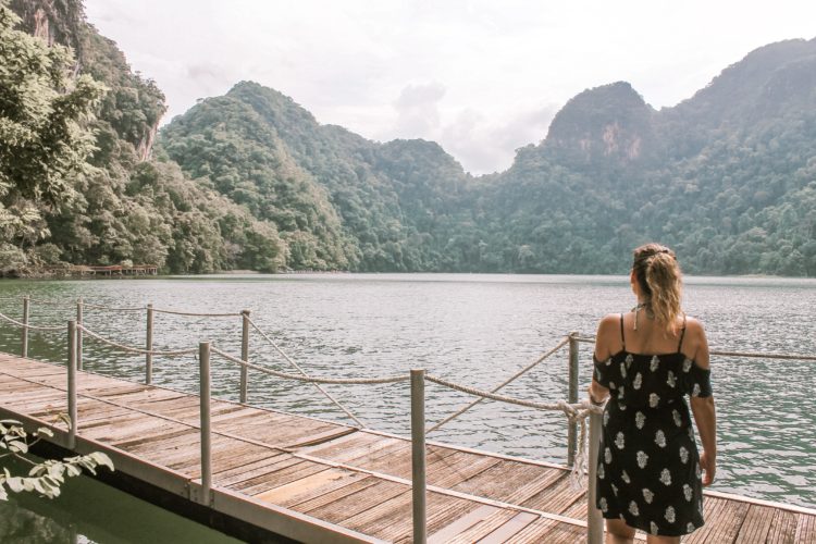 Girl standing on a board walk overlooking a lake in Langkawi