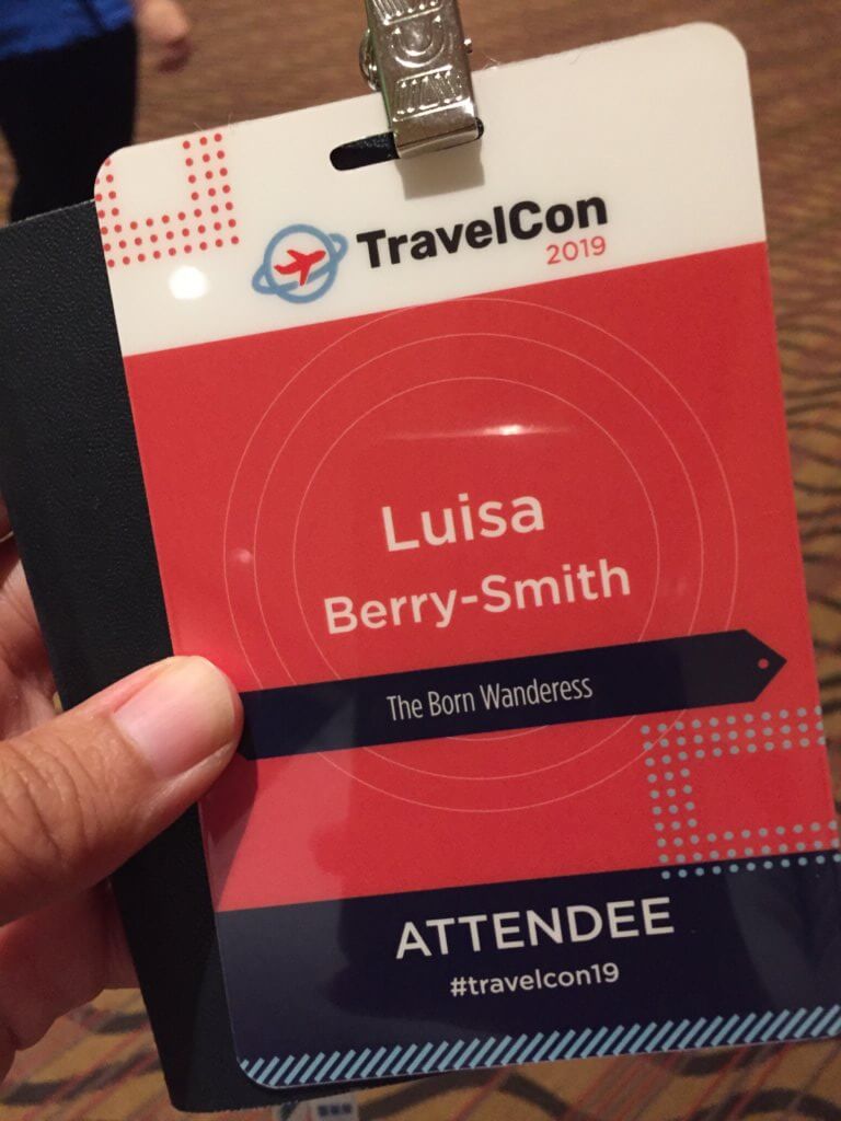 my event pass. it states from top to bottom Travelcon, my name Luisa Berry-Smith, my blog name the Born Wanderess, the word attendee and the hashtag travelcon19