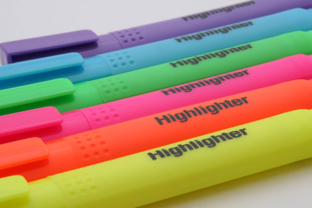 a yellow, orange, pink, green, blue and purple highlighter laying next to each other on a diagonal angle