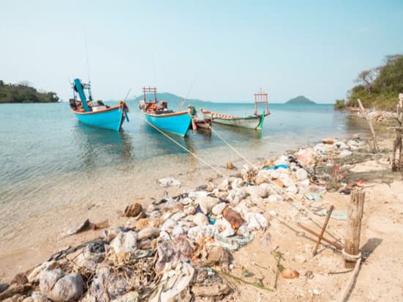 Polluted Cambodian coastline, with 4 boats moored just offshore