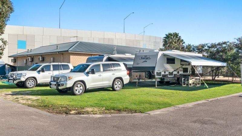 Cars and caravans are parked on a grassy area at the caravan park in Esperance