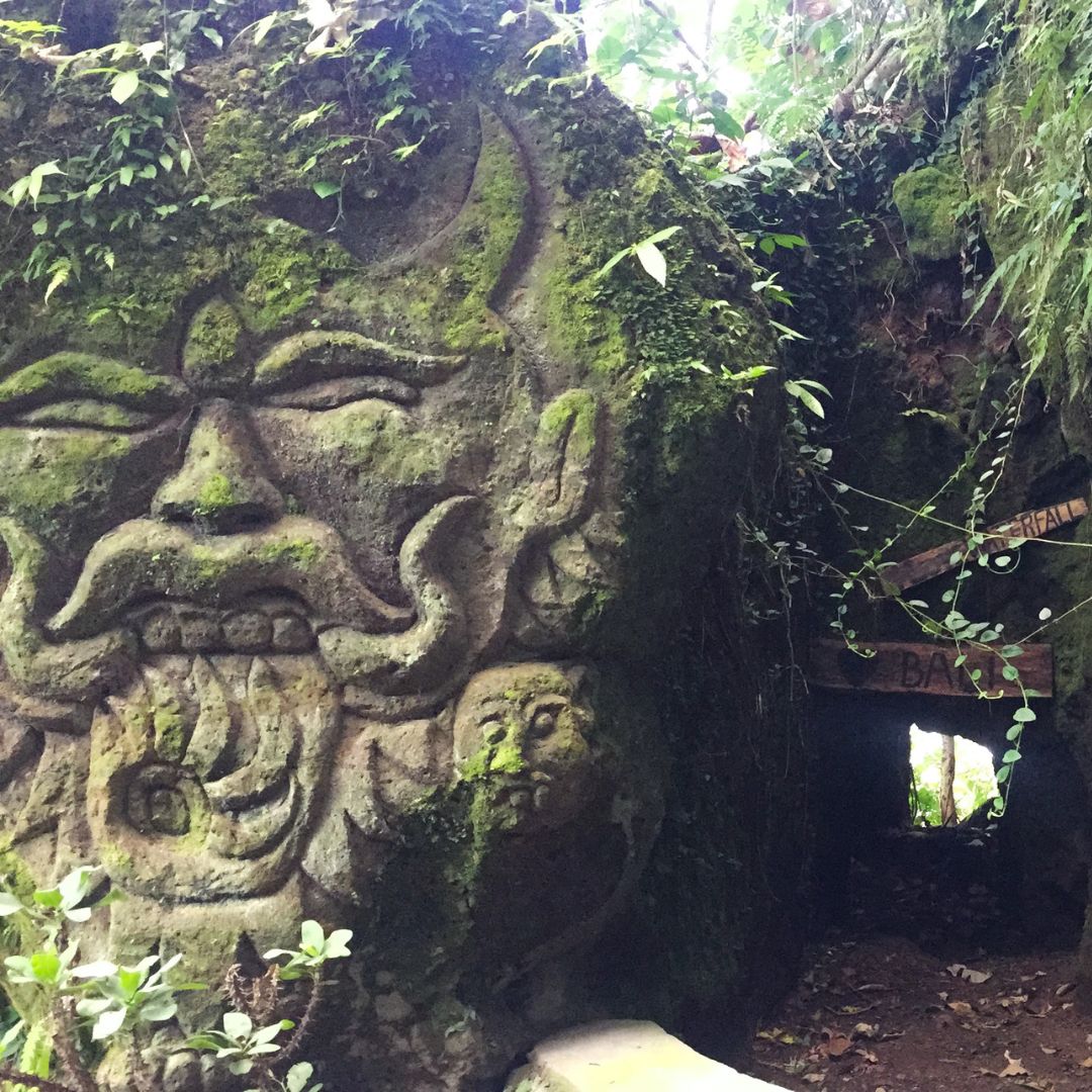 a craved face into the side of the walkway down to Kanto Lamp waterfall. Beyond the face on the right of the image is a hidden cave