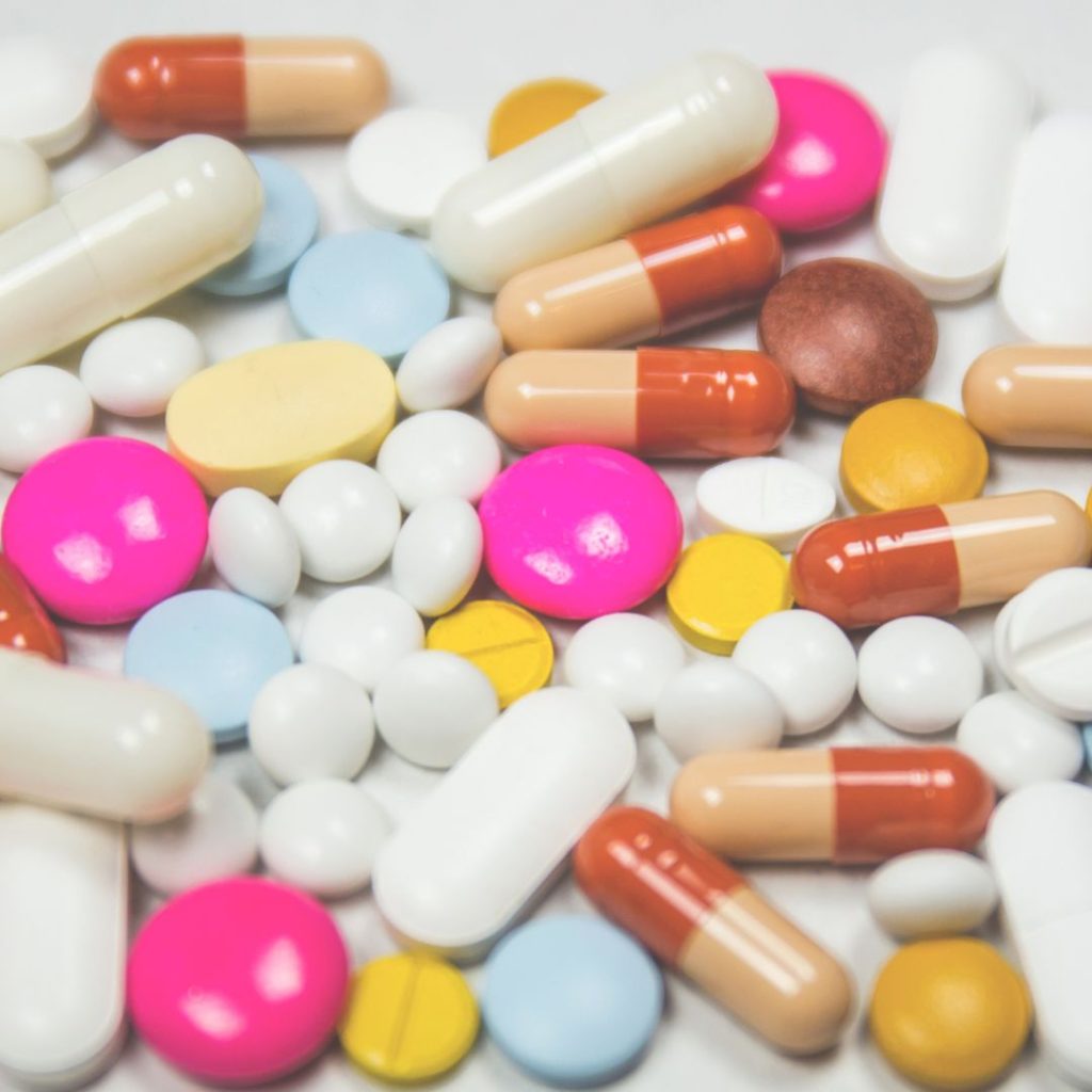 an assortment of different sized and different coloured pills that should always be packed into carry-on