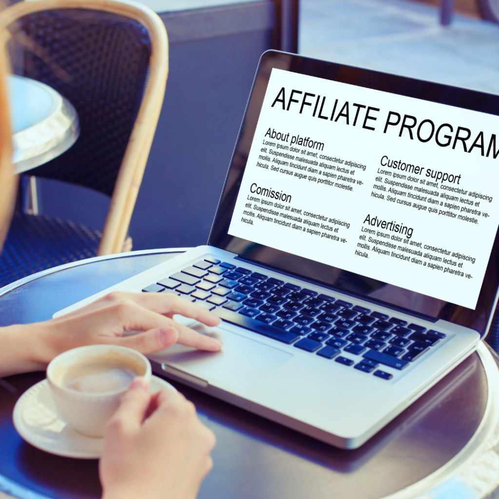 a hand is resting on a laptop that has the words affiliate marketing on the screen. the persons other hand holds a cup of coffee